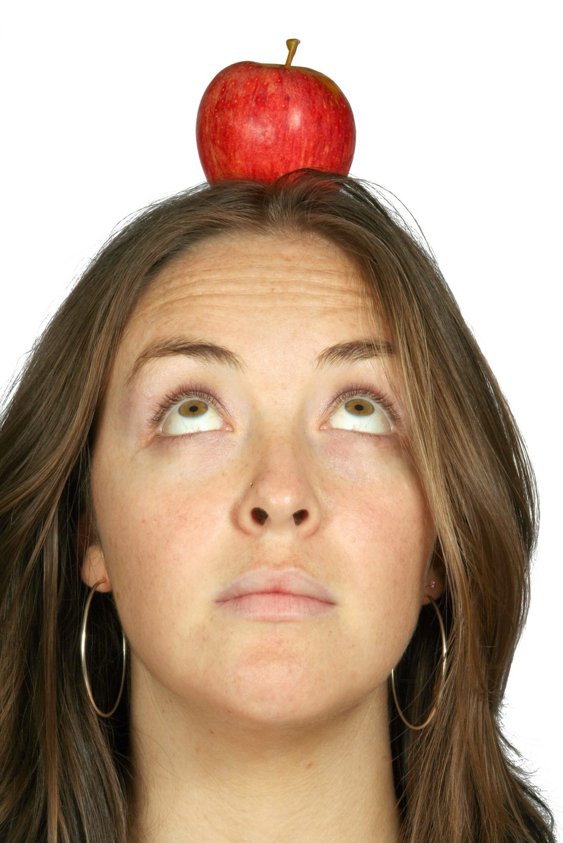 beautiful girl holding an apple on her head