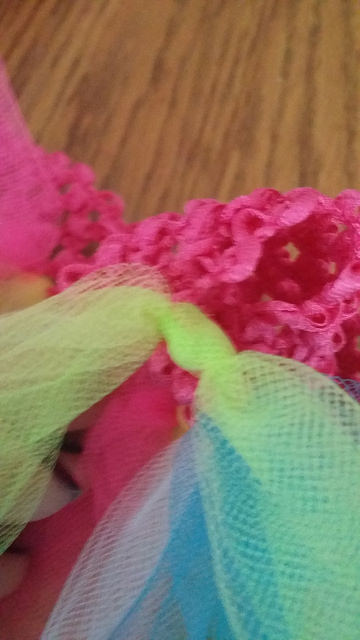 Pull it tight, taking care not to catch the neighboring tulle or crochet band